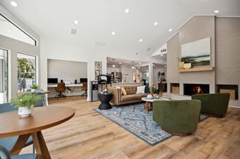 A living room with hardwood floors and a fireplace